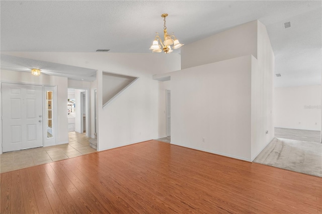 9145 Fort Jefferson Blvd, Orlando, FL 32822 - unfurnished living room with a chandelier, wood finished floors, and lofted ceiling