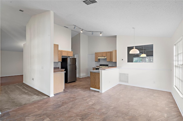 9145 Fort Jefferson Blvd, Orlando, FL 32822 - kitchen with freestanding refrigerator, range with electric cooktop, high vaulted ceiling, a peninsula, and under cabinet range hood