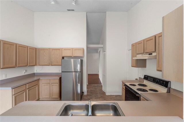 9145 Fort Jefferson Blvd, Orlando, FL 32822 - kitchen with freestanding refrigerator, electric stove, a sink, under cabinet range hood, and light brown cabinets