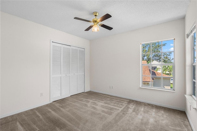 9145 Fort Jefferson Blvd, Orlando, FL 32822 - unfurnished bedroom featuring carpet flooring, a closet, a textured ceiling, a ceiling fan, and baseboards