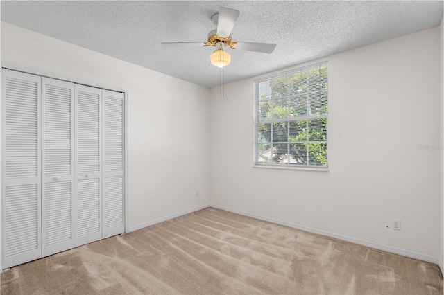 9145 Fort Jefferson Blvd, Orlando, FL 32822 - unfurnished bedroom featuring carpet, a textured ceiling, a closet, and baseboards