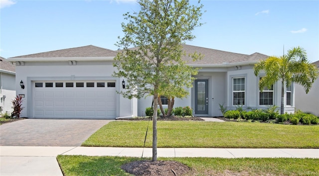 15049 Canopy Cover Dr, Winter Garden, FL 34787 - view of front of home with stucco siding, a garage, driveway, and a front yard