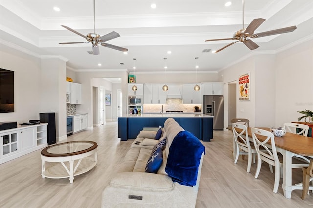 15049 Canopy Cover Dr, Winter Garden, FL 34787 - living room with a ceiling fan, recessed lighting, crown molding, light wood-style floors, and wine cooler