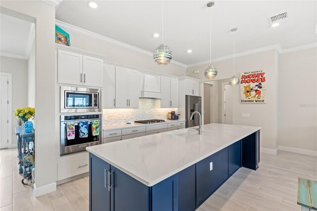 15049 Canopy Cover Dr, Winter Garden, FL 34787 - kitchen featuring appliances with stainless steel finishes, a sink, a spacious island, crown molding, and white cabinets