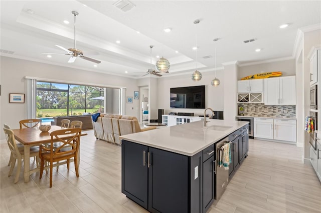 15049 Canopy Cover Dr, Winter Garden, FL 34787 - kitchen featuring a sink, ceiling fan, white cabinetry, dark cabinetry, and open floor plan