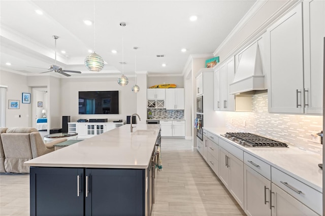 15049 Canopy Cover Dr, Winter Garden, FL 34787 - kitchen with custom range hood, stainless steel appliances, open floor plan, ornamental molding, and tasteful backsplash