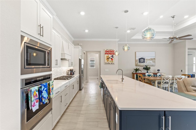 15049 Canopy Cover Dr, Winter Garden, FL 34787 - kitchen featuring appliances with stainless steel finishes, a sink, ornamental molding, a large island, and open floor plan