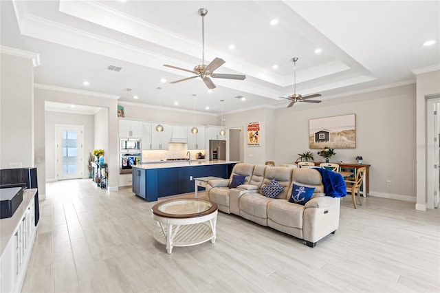 15049 Canopy Cover Dr, Winter Garden, FL 34787 - living area featuring a ceiling fan, a tray ceiling, recessed lighting, crown molding, and baseboards