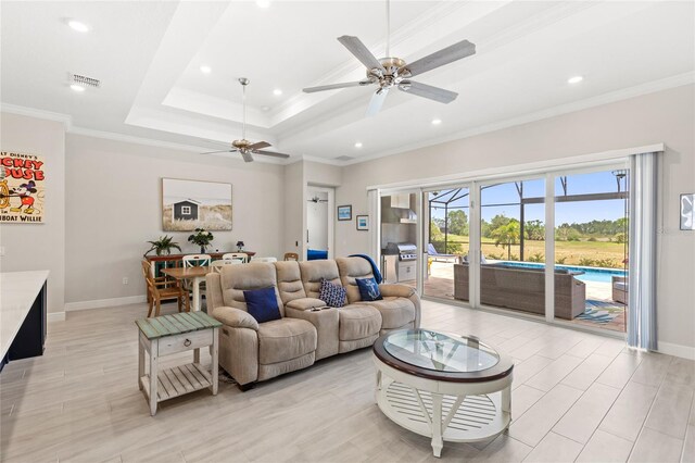15049 Canopy Cover Dr, Winter Garden, FL 34787 - living room with ceiling fan, baseboards, crown molding, recessed lighting, and a raised ceiling