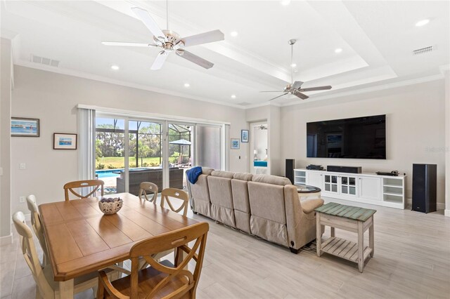 15049 Canopy Cover Dr, Winter Garden, FL 34787 - dining space with ceiling fan, crown molding, recessed lighting, light wood-type flooring, and a raised ceiling