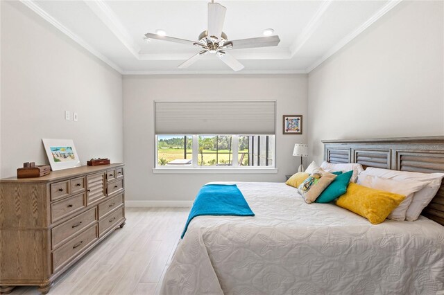 15049 Canopy Cover Dr, Winter Garden, FL 34787 - bedroom with light wood finished floors, a raised ceiling, ornamental molding, baseboards, and a ceiling fan