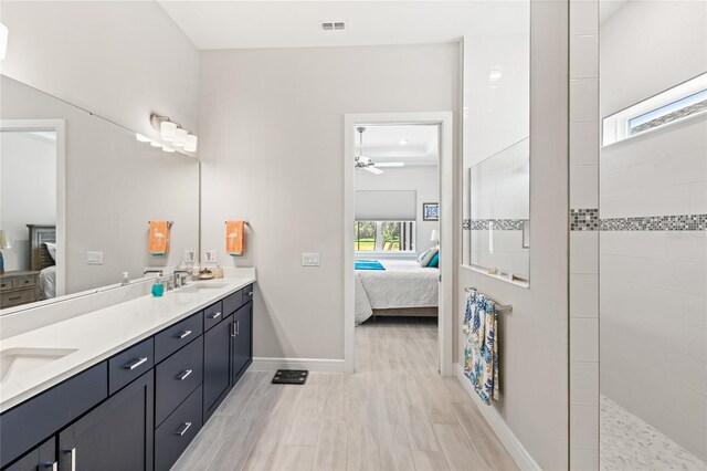 15049 Canopy Cover Dr, Winter Garden, FL 34787 - ensuite bathroom with double vanity, ceiling fan, walk in shower, baseboards, and wood finished floors