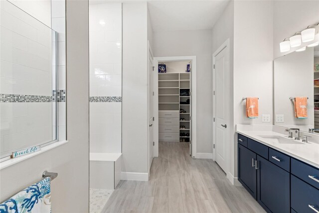 15049 Canopy Cover Dr, Winter Garden, FL 34787 - full bath with vanity, baseboards, a walk in closet, and wood finished floors