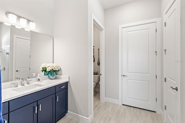 15049 Canopy Cover Dr, Winter Garden, FL 34787 - full bathroom with vanity, toilet, wood finished floors, baseboards, and a shower