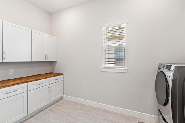 15049 Canopy Cover Dr, Winter Garden, FL 34787 - laundry room with washer / clothes dryer, cabinet space, and baseboards