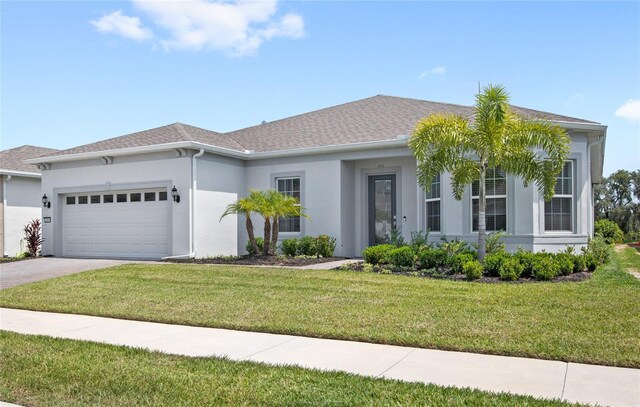 15049 Canopy Cover Dr, Winter Garden, FL 34787 - ranch-style home featuring an attached garage, stucco siding, a front yard, and concrete driveway