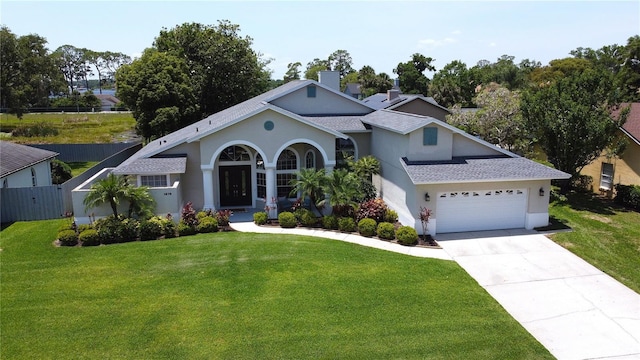 1676 Bear Crossing Cir, Apopka, FL 32703 - view of front facade featuring roof with shingles, driveway, stucco siding, and a garage