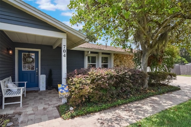 704 Tangerine Ct, Winter Garden, FL 34787 - doorway to property with covered porch and stone siding