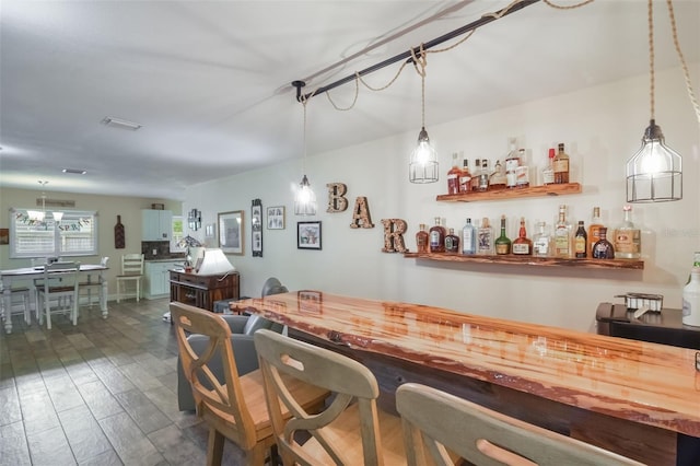 704 Tangerine Ct, Winter Garden, FL 34787 - indoor dry bar featuring hanging light fixtures and dark wood-type flooring