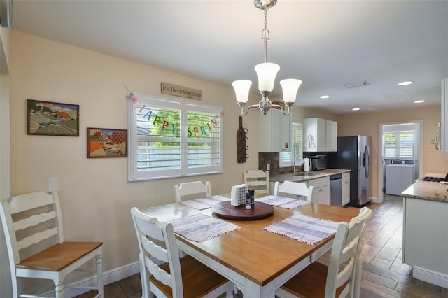 704 Tangerine Ct, Winter Garden, FL 34787 - dining room with a chandelier, baseboards, wood finished floors, and recessed lighting