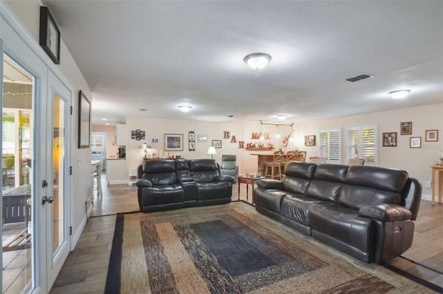 704 Tangerine Ct, Winter Garden, FL 34787 - living area featuring wood finished floors, bar area, and baseboards