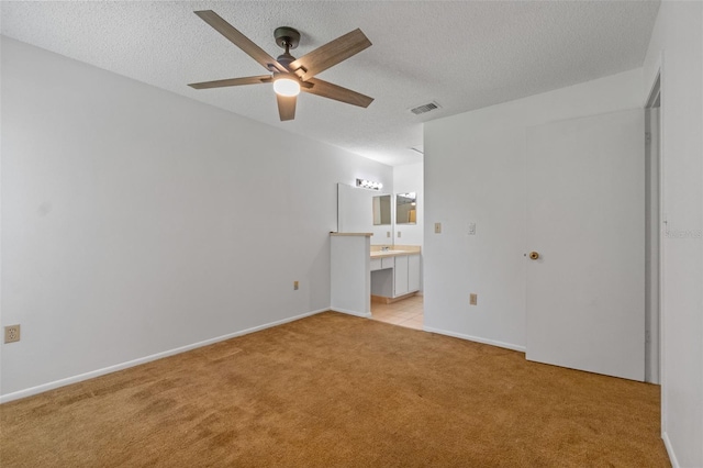 2750 King Oak Cir, Saint Cloud, FL 34769 - unfurnished room featuring light carpet, ceiling fan, and a textured ceiling