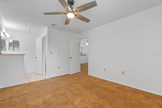 2750 King Oak Cir, Saint Cloud, FL 34769 - unfurnished living room featuring light colored carpet, attic access, ceiling fan, and a textured ceiling