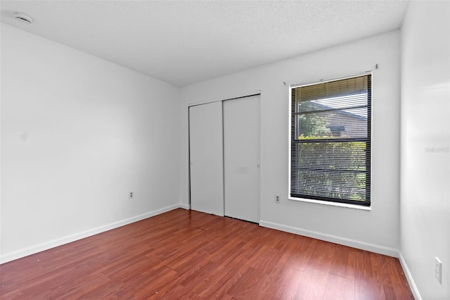 2750 King Oak Cir, Saint Cloud, FL 34769 - unfurnished bedroom featuring wood finished floors and a closet