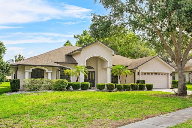 4905 Emilee Grace Ln, Saint Cloud, FL 34771 - view of front of home featuring a garage, a front yard, stucco siding, and concrete driveway