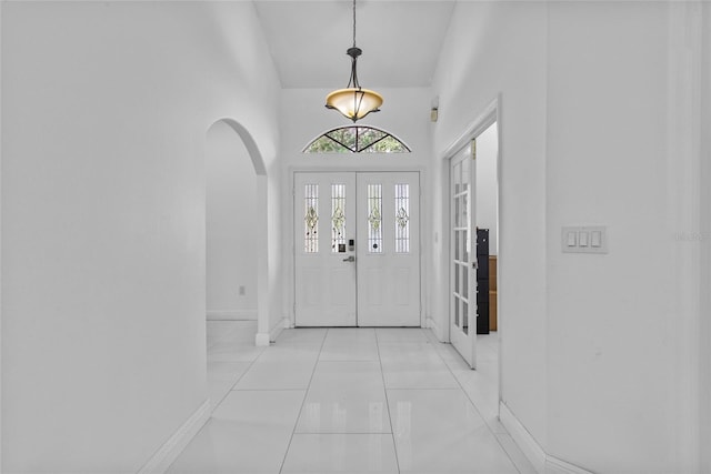 4905 Emilee Grace Ln, Saint Cloud, FL 34771 - foyer featuring arched walkways, baseboards, and light tile patterned flooring