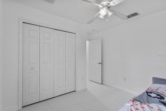 4905 Emilee Grace Ln, Saint Cloud, FL 34771 - bedroom with light tile patterned floors, a closet, baseboards, and ceiling fan