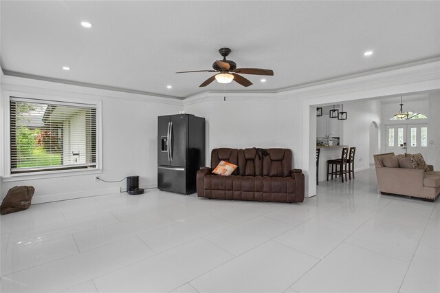 4905 Emilee Grace Ln, Saint Cloud, FL 34771 - living room featuring a ceiling fan, light tile patterned floors, recessed lighting, baseboards, and arched walkways