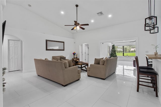 4905 Emilee Grace Ln, Saint Cloud, FL 34771 - living area featuring arched walkways, ceiling fan, recessed lighting, light tile patterned floors, and high vaulted ceiling