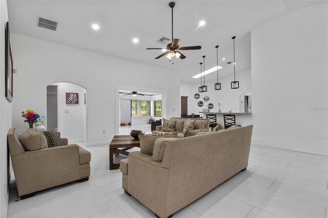 4905 Emilee Grace Ln, Saint Cloud, FL 34771 - living room with arched walkways, a ceiling fan, recessed lighting, light tile patterned floors, and baseboards