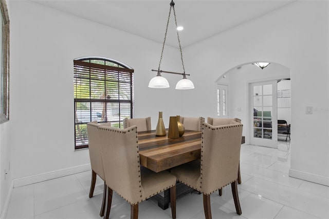 4905 Emilee Grace Ln, Saint Cloud, FL 34771 - dining space with arched walkways, baseboards, and light tile patterned floors