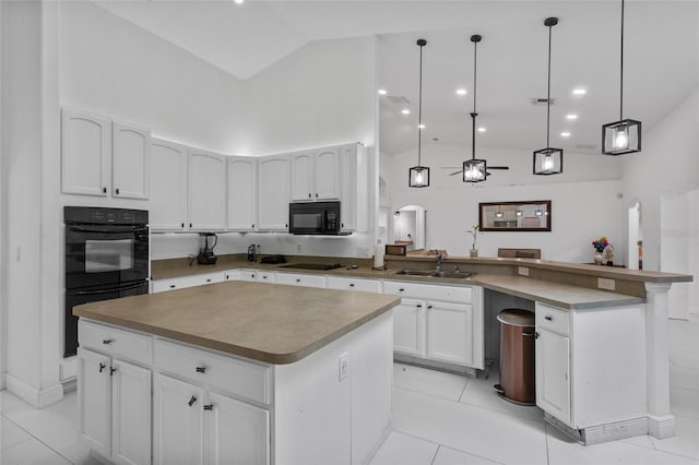 4905 Emilee Grace Ln, Saint Cloud, FL 34771 - kitchen featuring a peninsula, arched walkways, a sink, black appliances, and high vaulted ceiling