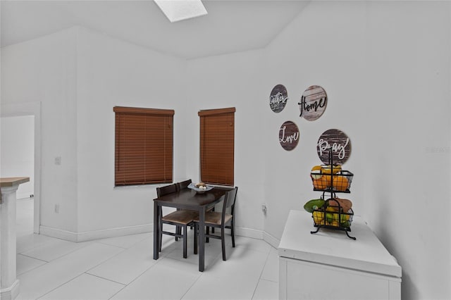 4905 Emilee Grace Ln, Saint Cloud, FL 34771 - dining area featuring a skylight, light tile patterned flooring, and baseboards