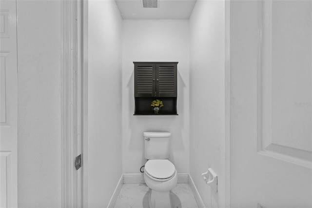 4905 Emilee Grace Ln, Saint Cloud, FL 34771 - bathroom with marble finish floors, baseboards, and toilet
