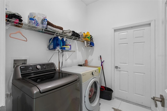 4905 Emilee Grace Ln, Saint Cloud, FL 34771 - washroom with separate washer and dryer and light tile patterned floors
