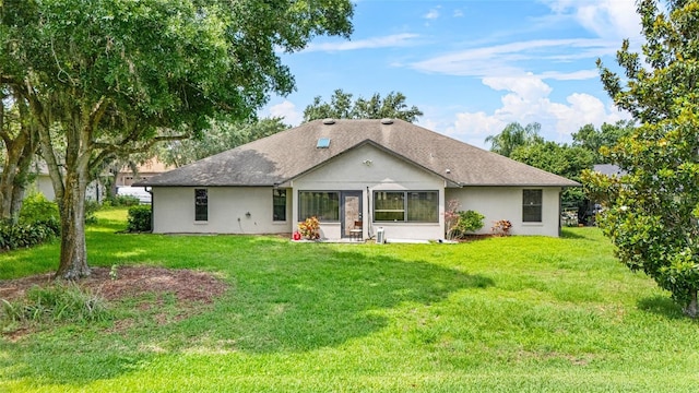 4905 Emilee Grace Ln, Saint Cloud, FL 34771 - rear view of house featuring a lawn, stucco siding, and a shingled roof
