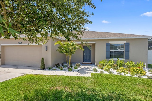 15356 White Tail Loop, Mascotte, FL 34753 - view of front facade with stucco siding, a front yard, concrete driveway, and an attached garage