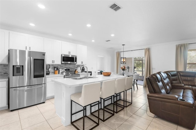 15356 White Tail Loop, Mascotte, FL 34753 - kitchen featuring stainless steel appliances, open floor plan, light tile patterned floors, backsplash, and recessed lighting