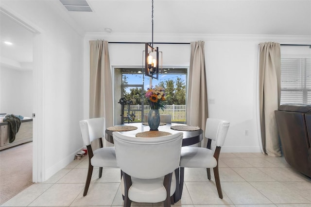 15356 White Tail Loop, Mascotte, FL 34753 - dining area featuring a chandelier, ornamental molding, baseboards, and light tile patterned floors