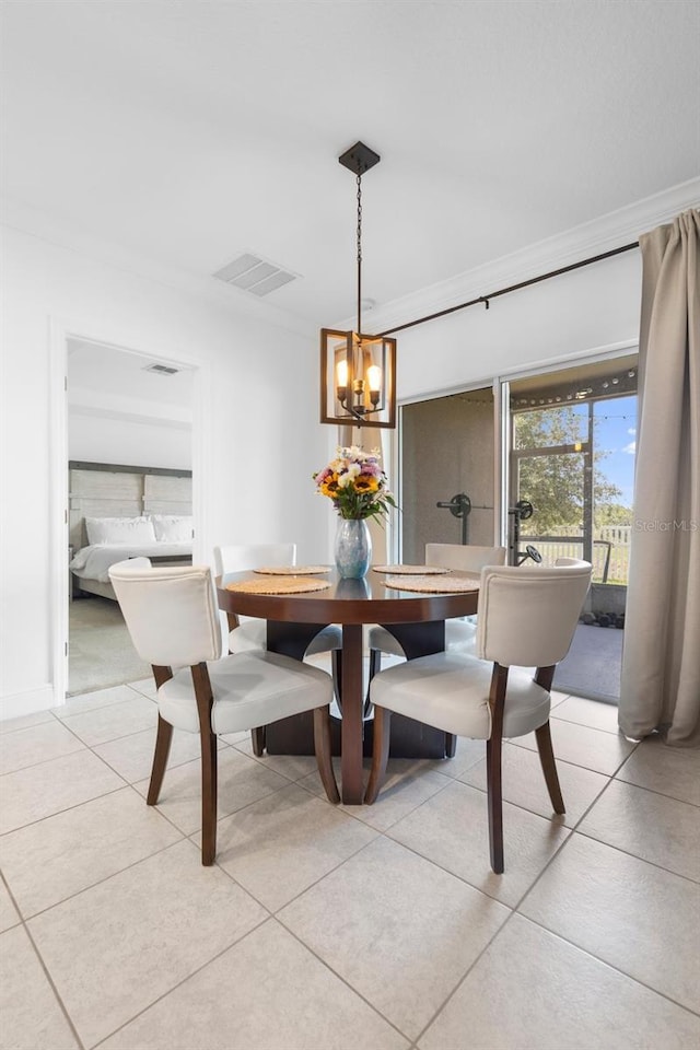 15356 White Tail Loop, Mascotte, FL 34753 - dining room with light tile patterned floors, a chandelier, ornamental molding, and baseboards