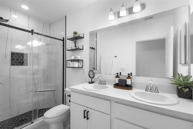 15356 White Tail Loop, Mascotte, FL 34753 - bathroom featuring double vanity, a shower stall, and toilet