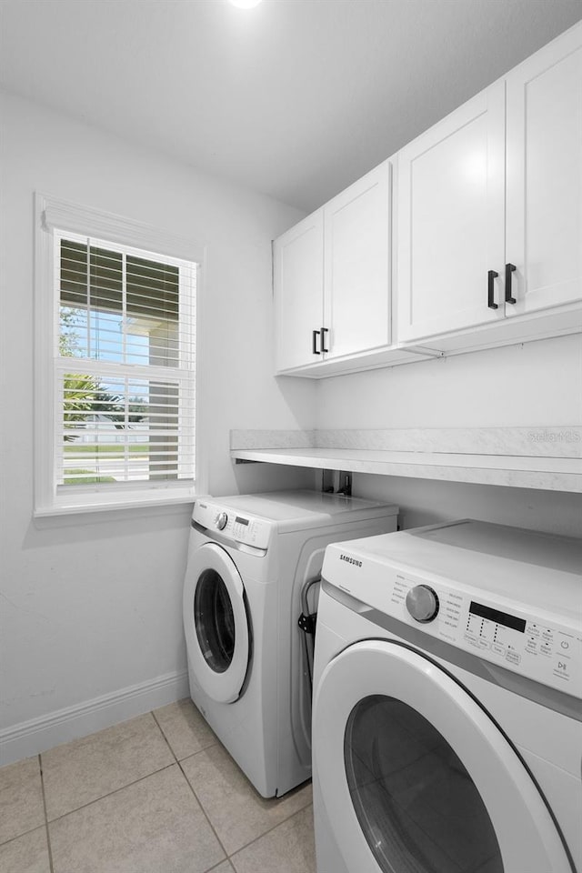 15356 White Tail Loop, Mascotte, FL 34753 - laundry area with cabinet space, washing machine and clothes dryer, light tile patterned flooring, and baseboards