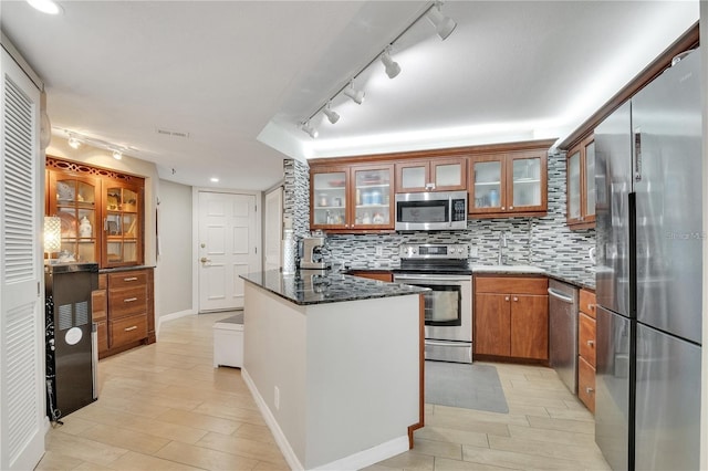 400 E Colonial Dr Unit 1609, Orlando, FL 32803 - kitchen with appliances with stainless steel finishes, track lighting, a sink, tasteful backsplash, and brown cabinets