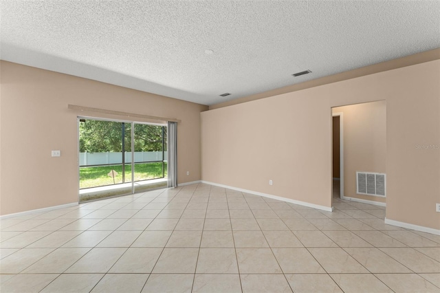 476 Basking Ridge Ct, Ocoee, FL 34761 - empty room featuring a textured ceiling, baseboards, and light tile patterned flooring