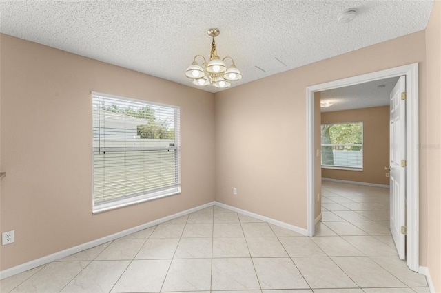476 Basking Ridge Ct, Ocoee, FL 34761 - unfurnished room with a chandelier, a textured ceiling, baseboards, light tile patterned flooring, and a smoke detector