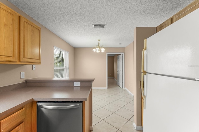 476 Basking Ridge Ct, Ocoee, FL 34761 - kitchen featuring freestanding refrigerator, stainless steel dishwasher, a chandelier, light tile patterned floors, and a peninsula
